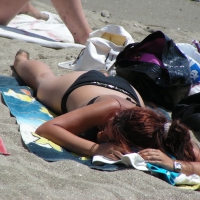 Sexy girl in black bikini dressing on the beach D_02.JPG