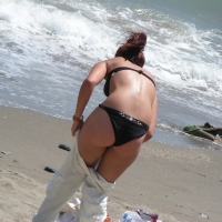 Sexy girl in black bikini dressing on the beach D_13.JPG