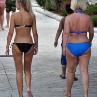 Sexy blonde bikini girl walking with mom Blonde bikini girl with mom
