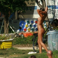 Two cute nudist girls showering completely naked on a hot day at the beach 0015.jpg