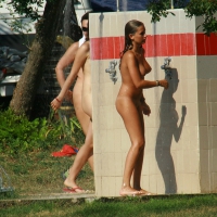 Two cute nudist girls showering completely naked on a hot day at the beach 0024.jpg