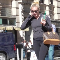 Hot blonde in leggings on phone