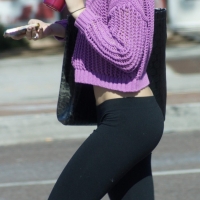 Beautiful skinny blonde in tight leggings and purple crop top showing sexy stomach Amazing skinny blonde in leggings