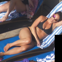 Milf laying out in black bikini by the pool Milf in black bikini