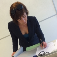 Mature business woman in jeans and showing some cleavage Mature business woman