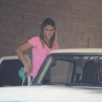 Cute girl washing her Ford pickup truck at the car wash Cute girl washing her truck