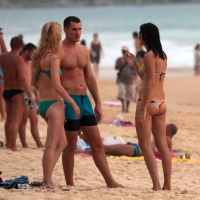 Sexy brunette in thong bikini and blonde friend in green bikini at the beach Sexy brunette and blonde at the beach