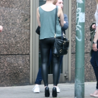 Sexy girl in shiny pleather pants and heels on the street Girl in pleather pants and heels