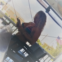 Big boobed blonde in a bikini at the beach bar Big boobed bikini blonde