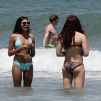Brunette and redhead on the beach in bikinis looking sexy Brunette and redhead on the beach
