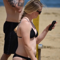 Chunky blonde in a black bikini on the beach Chunky blonde black bikini