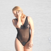 See through swimsuit blonde on the beach showing her tits off See through swimsuit blonde