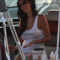 Bikini babe on a boat with a wet see through white shirt showing her tits Bikini babe in see through wet white shirt