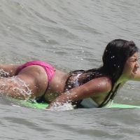 Brunette bikini girl on the beach and surfing in her bikini Brunette surfer beach girl