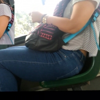 Cute girl on the bus in jeans