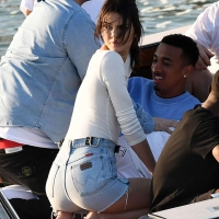 Kendall Jenner in Miami on a boat in jean shorts and a white shirt with no bra showing her nipples Kendall Jenner in shorts and white shirt with no bra