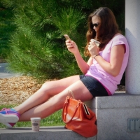 Bunch of candid babes in public in shorts 68843468@N04_36982823031_checking her phone.jpg