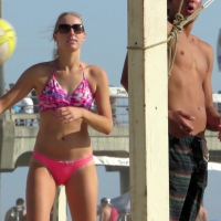 Blonde babe playing beach volleyball