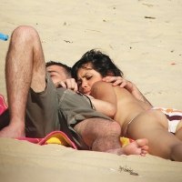 Topless girl playing with her man