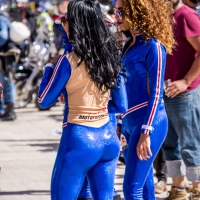 Sexy car models in tight shiny blue legging type pants Sexy car models in blue shiny pants