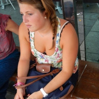 Girl at the bus stop in low cut shirt showing her cleavage Girl showing nice cleavage