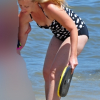 Blonde at the beach in a polka dot top and black bottom Polka dot blonde