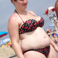 Fat chick with big boobs at the beach in a bikini Fat chick at the beach