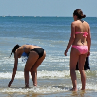 Two teen friends in bikinis at the beach Two beach teen friends