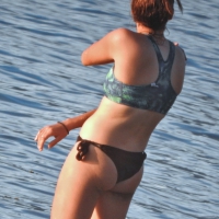 Sexy beach girl in a Nike sports bra and black bikini bottom Beach girl in sports bra