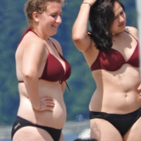 Thick beach girl in a bikini with her friends Thick beach girl with friends