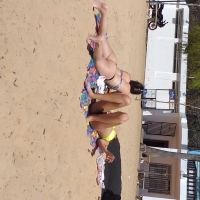 Beach girls getting some sun in thong bikinis Beach girls laying out