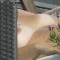 Mature neighbor out sunbathing in pink bikini and topless Mature neighbor sunbathing