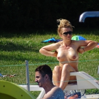 Topless lady at the pool with nice tits Topless at the pool