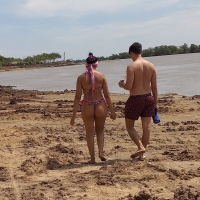 Big booty brunette in a little thong bikini while with her boyfriend Big booty brunette in thong with boyfriend