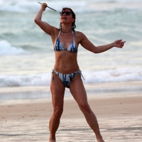 Older lady playing on the beach in her bikini Older lady playing on the beach