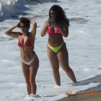 Mom and daughter Latinas on the beach taking pictures in thong bikinis Mom and daughter in thong bikinis