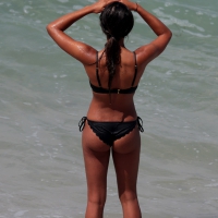 Black girl on the beach in a bikini with an incredible ass while surfing Black beach babe with incredible ass