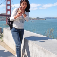 Beautiful brunette taking pics by the Golden Gate bridge in San Francisco Beautiful brunette in jeans in San Francisco