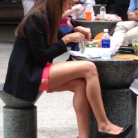Sexy girl eating in pink skirt with nice legs almost upskirted Sexy girl eating in pink skirt