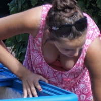 Ice cream girl in green shorts and tank top showing her nice cleavage Ice cream babe in shorts with nice cleavage