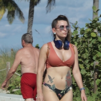 Beach babe in Florida in thong ad top showing cleavage from her big boobs Beach babe with huge boobs