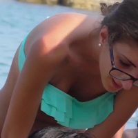 Skinny bikini babe with glasses on the beach