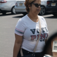 Big boobed mature thick lady walking in the parking lot in a skirt Big boobed mature lady in skirt