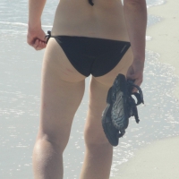 Lady on the beach in black bikini with nice ass Lady on the beach