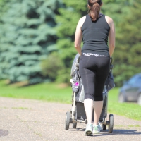 Milf out pushing the stroller in leggings with a nice booty Milf out for a walk in leggings