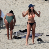 Big boobed babe with pokies in a bikini on the beach with friends Big boobs and pokies on the beach