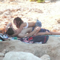 Sexy babe making out with her boyfriend on the beach