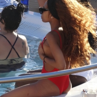 Sexy black girl in red swimsuit at the pool with side boob and a nice ass Sexy black girl in red swimsuit
