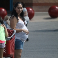 Pregnant Latina milf in shorts going into Target Pregnant Latina in shorts
