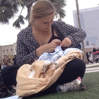 Lady with fake boob pretending to breast feed her baby in public Lady breast feeding with fake boob